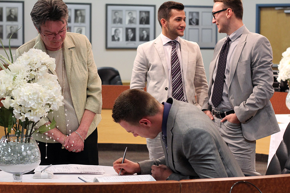 photo of husband signing papers