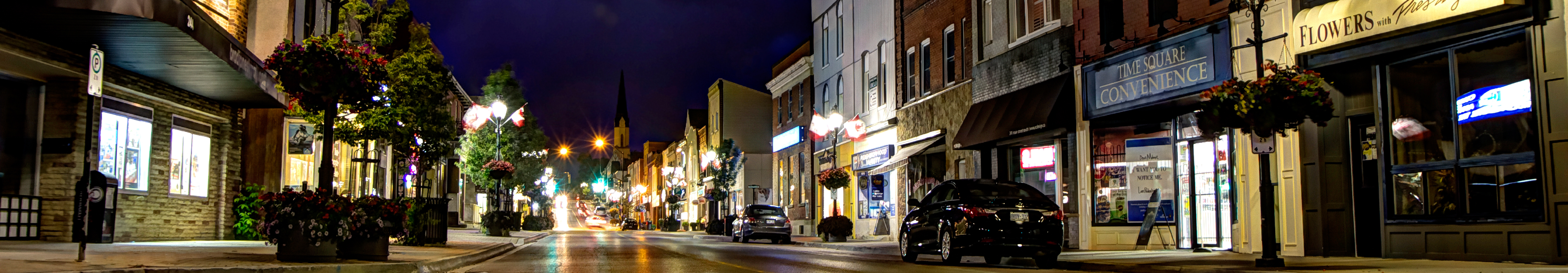 A street with buildings surrounding it that has been darkened from a power outage. 